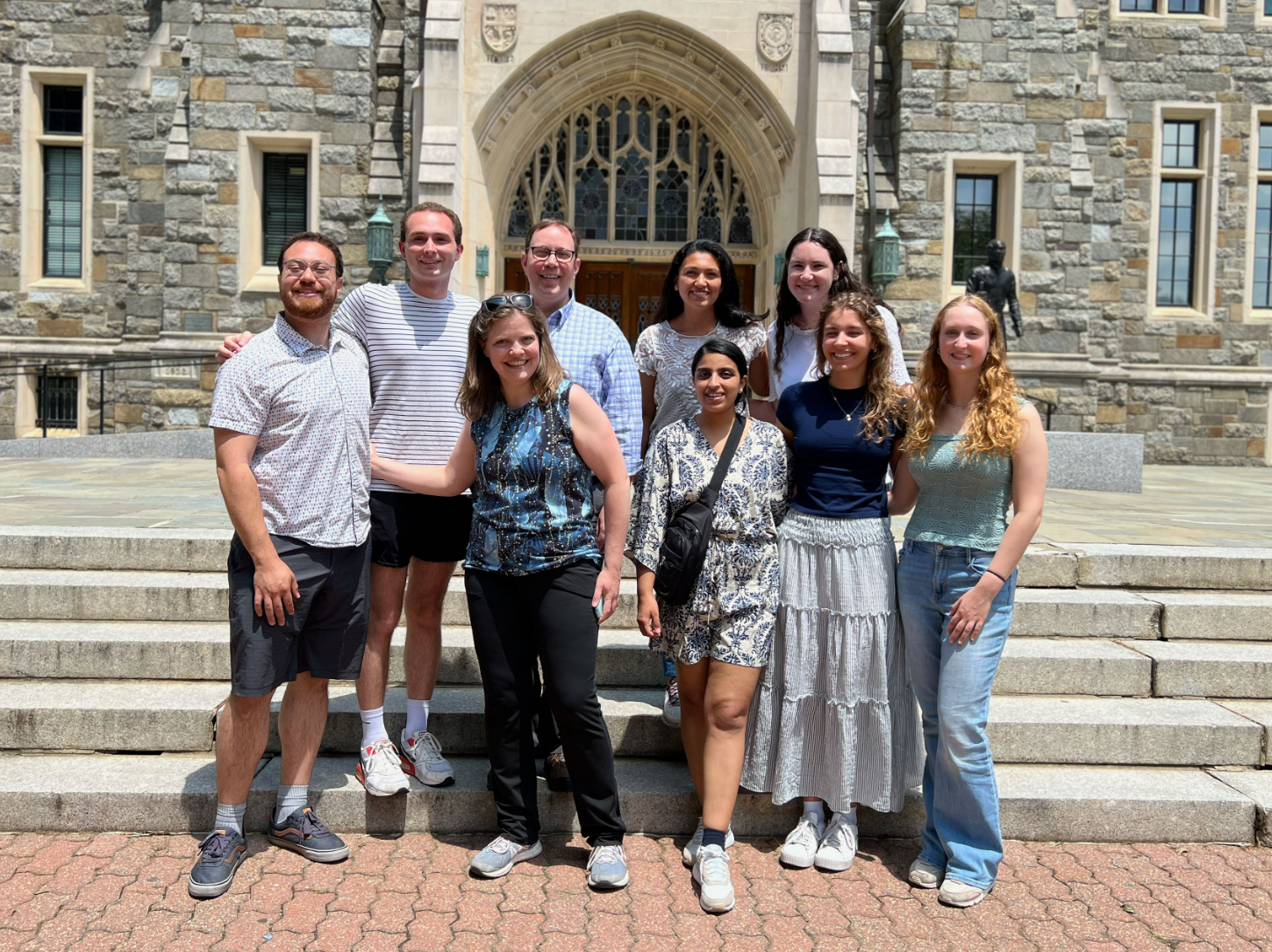 2 professors and 7 students standing in front of a building on Georgetown's campus